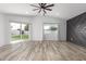 Spacious living room with a ceiling fan, wood-look floors, and sliding glass door at 1038 N 78Th Pl, Scottsdale, AZ 85257