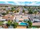 Stunning aerial view of a peaceful neighborhood featuring lush greenery, mature trees, and homes with pools surrounded by mountains at 10836 N 108Th N Pl, Scottsdale, AZ 85259