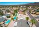 Expansive aerial view of a residential neighborhood with mature landscaping, backyard pools, and mountain views at 10836 N 108Th N Pl, Scottsdale, AZ 85259