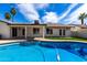 Beautiful backyard featuring a sparkling pool, patio, and lush artificial turf for outdoor enjoyment at 10836 N 108Th N Pl, Scottsdale, AZ 85259