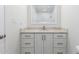 Bright bathroom with single sink, marble counters and backsplash and white cabinets at 10836 N 108Th N Pl, Scottsdale, AZ 85259