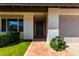 Inviting front entry with tiled walkway, manicured shrubs, and stylish front door at 10836 N 108Th N Pl, Scottsdale, AZ 85259