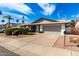 Attractive single-story home featuring a two-car garage, manicured landscaping, and a well-kept lawn at 10836 N 108Th N Pl, Scottsdale, AZ 85259