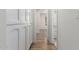 Bright hallway with hardwood floors and white cabinets for linen and extra storage space at 10836 N 108Th N Pl, Scottsdale, AZ 85259