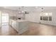 Open-concept kitchen featuring a large island, modern lighting, and a decorative brick fireplace focal point at 10836 N 108Th N Pl, Scottsdale, AZ 85259