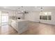 Open-concept kitchen featuring a large island, modern lighting, and a decorative brick fireplace focal point at 10836 N 108Th N Pl, Scottsdale, AZ 85259