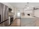 This kitchen features stainless steel appliances, white cabinets and an island with pendant lighting at 10836 N 108Th N Pl, Scottsdale, AZ 85259