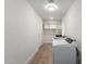 Functional laundry room with overhead cabinets, washer and dryer hookups and wood-look flooring at 10836 N 108Th N Pl, Scottsdale, AZ 85259