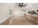 Spacious living room featuring a contemporary lighting fixture, large ceiling fan, and an abundance of natural light at 10836 N 108Th N Pl, Scottsdale, AZ 85259