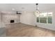 Bright living room with an eye-catching brick fireplace, modern ceiling fan, and ample natural light at 10836 N 108Th N Pl, Scottsdale, AZ 85259