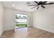 The living room has wood floors and glass doors that lead out to the backyard and pool at 10836 N 108Th N Pl, Scottsdale, AZ 85259