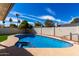 Sparkling pool with baja step, and spa surrounded by lush landscaping, and blue skies at 10836 N 108Th N Pl, Scottsdale, AZ 85259