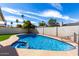 Beautiful pool and spa, surrounded by artificial turf and desert landscaping and block fence at 10836 N 108Th N Pl, Scottsdale, AZ 85259