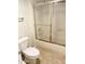 Functional bathroom featuring a glass-enclosed shower over tub and updated toilet at 12222 N Paradise Village S Pkwy # 409, Phoenix, AZ 85032