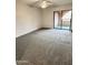Comfortable bedroom with plush carpeting and sliding glass doors to private patio at 12222 N Paradise Village S Pkwy # 409, Phoenix, AZ 85032