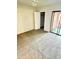 Bright bedroom with neutral carpet, closet, and sliding door access to the balcony at 12222 N Paradise Village S Pkwy # 409, Phoenix, AZ 85032