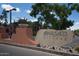 A welcoming stone sign for the Anasazi Village community amid lush greenery at 12222 N Paradise Village S Pkwy # 409, Phoenix, AZ 85032