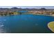 An aerial view showcasing a scenic lake surrounded by houses and lush landscaping at 12526 S 176Th Ave, Goodyear, AZ 85338