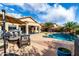 Large backyard featuring a refreshing pool, covered patio, and comfortable seating arrangements for relaxation at 12526 S 176Th Ave, Goodyear, AZ 85338