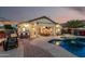 Charming backyard featuring a pool, covered patio with bar seating, and cozy lounge area for ultimate relaxation at 12526 S 176Th Ave, Goodyear, AZ 85338