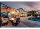 Backyard with covered patio, fire pit and a luxurious pool, designed for relaxing and entertaining guests at 12526 S 176Th Ave, Goodyear, AZ 85338