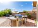 Backyard with built-in BBQ, hot tub, and seating area, perfect for entertaining guests outdoors at 12526 S 176Th Ave, Goodyear, AZ 85338