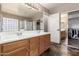 Bathroom with double sinks, a walk-in shower, and a walk-in closet at 12526 S 176Th Ave, Goodyear, AZ 85338