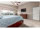 This bedroom features a large window, a dresser, and a door at 12526 S 176Th Ave, Goodyear, AZ 85338