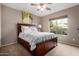 Bedroom with a large window and ceiling fan at 12526 S 176Th Ave, Goodyear, AZ 85338