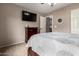 Bedroom featuring a TV and decorative mirror at 12526 S 176Th Ave, Goodyear, AZ 85338