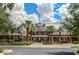 Exterior of a well-maintained clubhouse surrounded by palm trees and landscaped grounds in a gated community at 12526 S 176Th Ave, Goodyear, AZ 85338