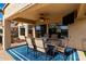 Cozy covered patio with comfortable seating, perfect for outdoor dining and entertaining with a TV at 12526 S 176Th Ave, Goodyear, AZ 85338