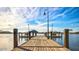 Scenic view of a wood dock with lights extending into a lake, offering serene waterfront living at 12526 S 176Th Ave, Goodyear, AZ 85338