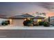 Charming single-Gathering home at twilight featuring mature landscaping, a tile roof, and a well-maintained front yard at 12526 S 176Th Ave, Goodyear, AZ 85338