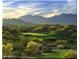 Picturesque golf course with lush green fairways surrounded by natural desert landscaping and mountain views at 12526 S 176Th Ave, Goodyear, AZ 85338