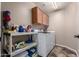 The laundry room features a washer, dryer, shelving, and storage cabinets at 12526 S 176Th Ave, Goodyear, AZ 85338