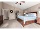 Serene main bedroom with neutral tones, a large window, and an ensuite bathroom at 12526 S 176Th Ave, Goodyear, AZ 85338