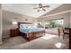Spacious main bedroom with a ceiling fan and a view of the backyard pool at 12526 S 176Th Ave, Goodyear, AZ 85338