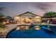 Gorgeous backyard pool with patio, lounge chairs, outdoor kitchen, and desert landscaping is perfect for entertaining at 12526 S 176Th Ave, Goodyear, AZ 85338