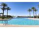 Resort-style community pool featuring palm trees, fountains and lounge seating, perfect for relaxation at 12526 S 176Th Ave, Goodyear, AZ 85338