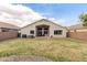 Expansive backyard featuring well-kept lawn, rock landscaping, and home exterior at 1289 E Baker Dr, San Tan Valley, AZ 85140