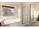 Bright bathroom features a soaking tub, separate shower and a large window for natural light at 1289 E Baker Dr, San Tan Valley, AZ 85140