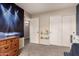 Bedroom featuring a closet, dresser, and playful concert scene tapestry on the wall at 1289 E Baker Dr, San Tan Valley, AZ 85140