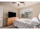 Bedroom features a ceiling fan, window for natural light, and dresser at 1289 E Baker Dr, San Tan Valley, AZ 85140
