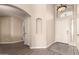 Bright entryway with wood flooring, archways, a decorative niche and a high ceiling at 1289 E Baker Dr, San Tan Valley, AZ 85140