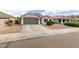 Lovely single-story home with a well-kept front yard and an attached two-car garage at 1289 E Baker Dr, San Tan Valley, AZ 85140