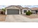 Single-story home featuring desert landscaping, wide driveway, and an attached garage at 1289 E Baker Dr, San Tan Valley, AZ 85140