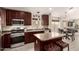Modern kitchen features stainless appliances, an island with seating, and plenty of storage at 1289 E Baker Dr, San Tan Valley, AZ 85140
