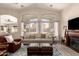 Comfortable living area with fireplace and large windows offering natural light at 1289 E Baker Dr, San Tan Valley, AZ 85140