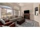Comfortable living room with a cozy fireplace and large windows for ample natural light at 1289 E Baker Dr, San Tan Valley, AZ 85140